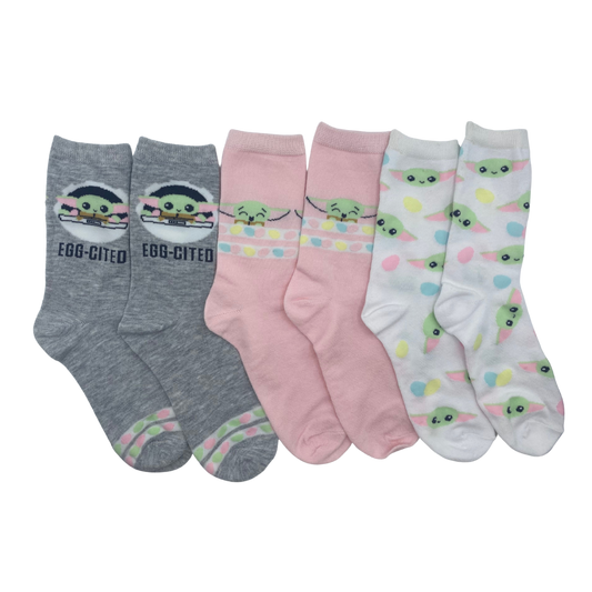 Three pairs of socks.

The first consists of a grey background with a Baby Yoda motif above the ankle with the phrase "egg-cited" below it.

The second consists of a grey background with a Baby Yoda motif above the ankle with two stripes containing colorful circles below it.

The third is a light grey sock with a motif of Baby Yoda's face printed all over.
