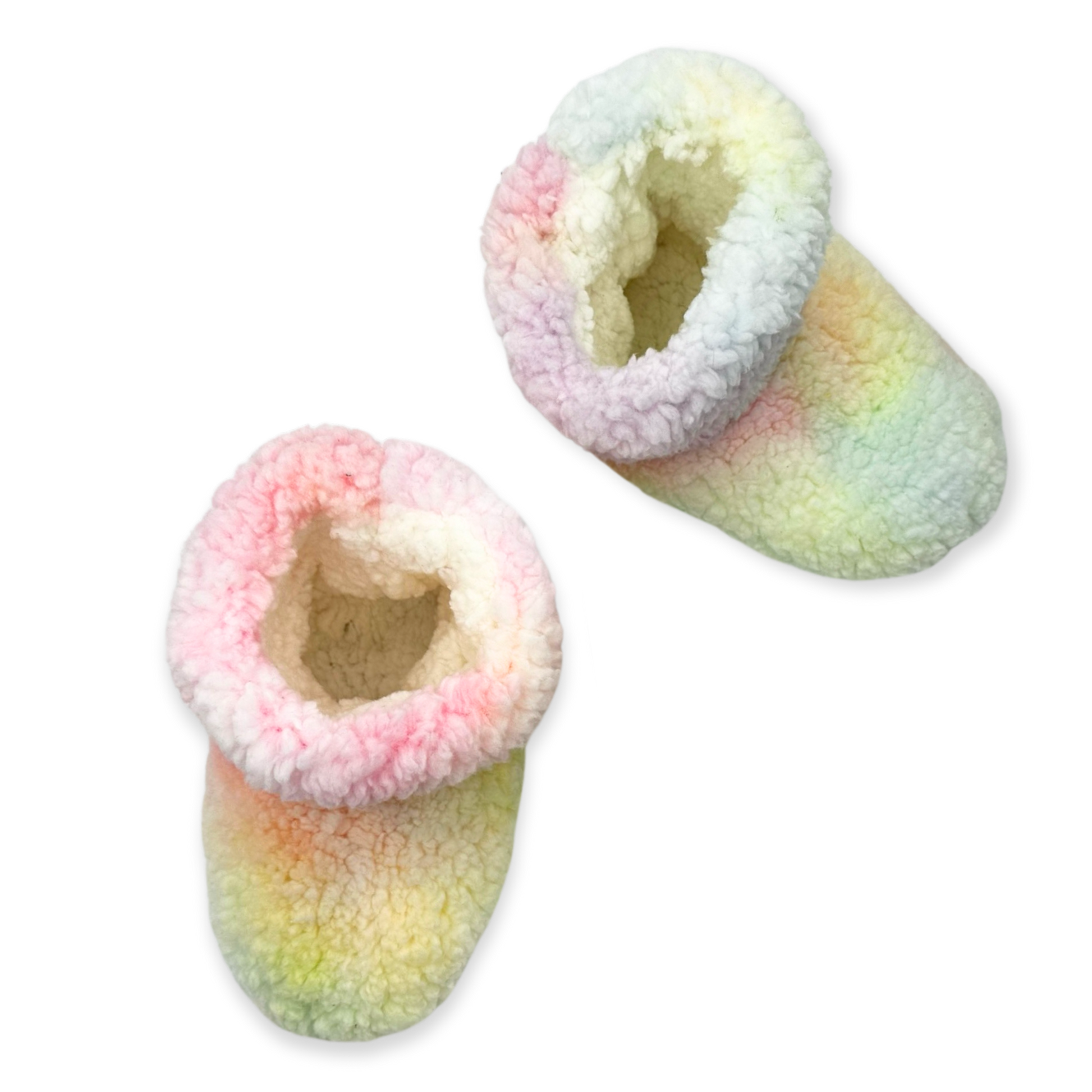 The image depicts a pair of rainbow tie dye slippers. The slippers are made of a soft, fuzzy material and have a closed toe design. They are perfect for keeping your feet warm and cozy on cold days.